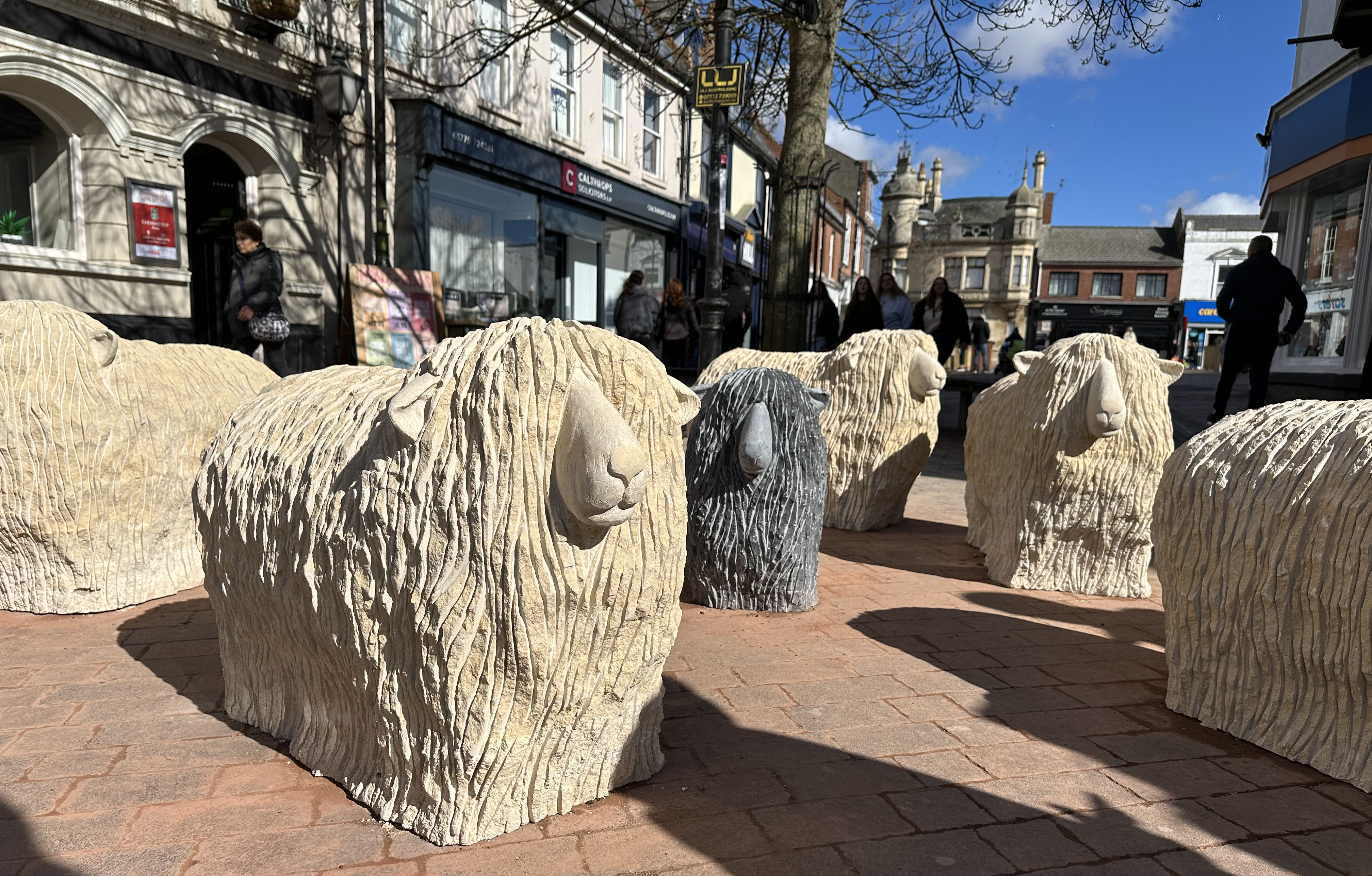 carved sculptures of stone sheep scalding